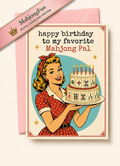 A retro-style birthday card with a pink envelope behind it. The card reads 'happy birthday to my favorite Mahjong Pal' and shows a vintage illustration of a woman holding a birthday cake.