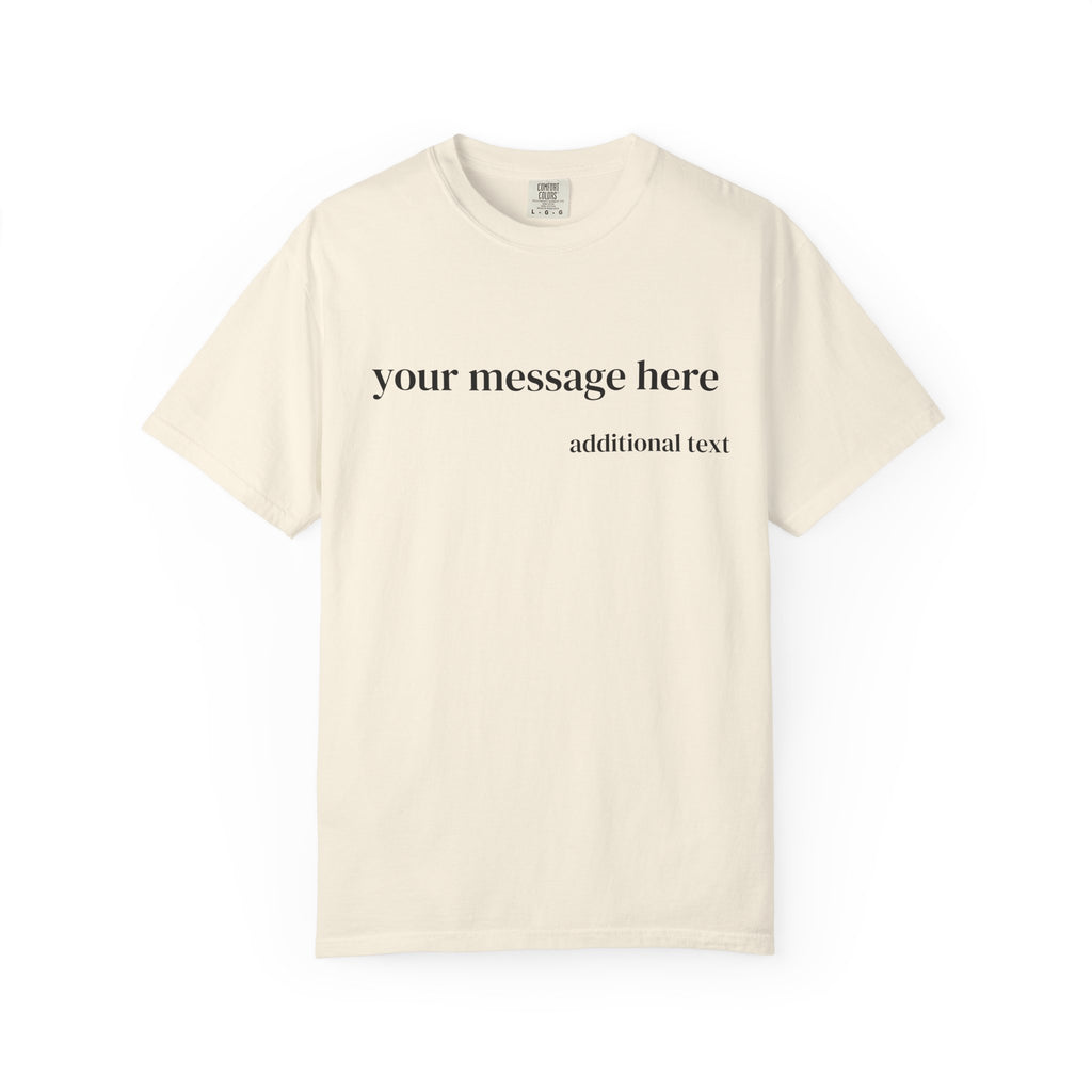 A cream-colored short-sleeve t-shirt with customizable black text on the chest reading 'your message here' and 'additional text' below it, displayed on a clean white background.