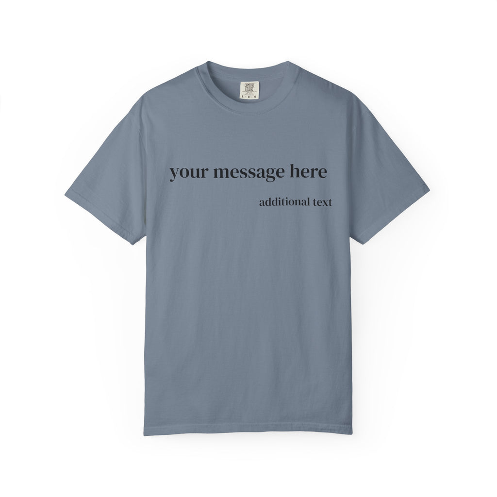 A close-up of a man wearing a dark charcoal gray t-shirt with white placeholder text that reads 'your message here' and 'additional text'.