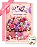 A pink birthday greeting card for a mahjong player, featuring a decorative bouquet of pink and purple flowers with mahjong tiles, a pink envelope behind it, a pink ribbon banner reading 'MahjongFun', and an 'As Seen On' badge.