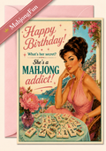 A retro-style birthday greeting card featuring a pin-up illustration of a woman at a mahjong table with the text 'Happy Birthday! What's her secret? She's a MAHJONG addict!'. A pink envelope is visible behind the card, and a diagonal banner reads 'MahjongFun'.