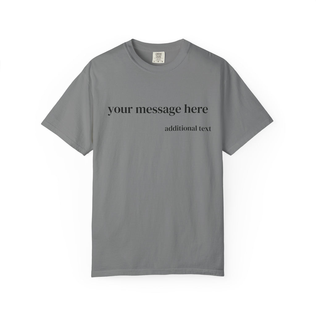 A close-up of a man wearing a dark charcoal gray t-shirt with white placeholder text that reads 'your message here' and 'additional text'.