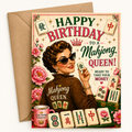 A retro-style birthday greeting card with a kraft paper envelope behind it. The card features vintage illustration art of a woman in sunglasses holding a mahjong tile, surrounded by pink flowers and mahjong tiles, with the text 'HAPPY BIRTHDAY TO A Mahjong QUEEN!'.