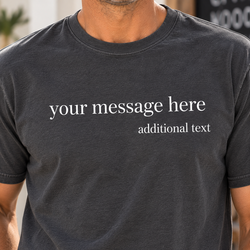 A close-up of a man wearing a dark charcoal gray t-shirt with white placeholder text that reads 'your message here' and 'additional text'.