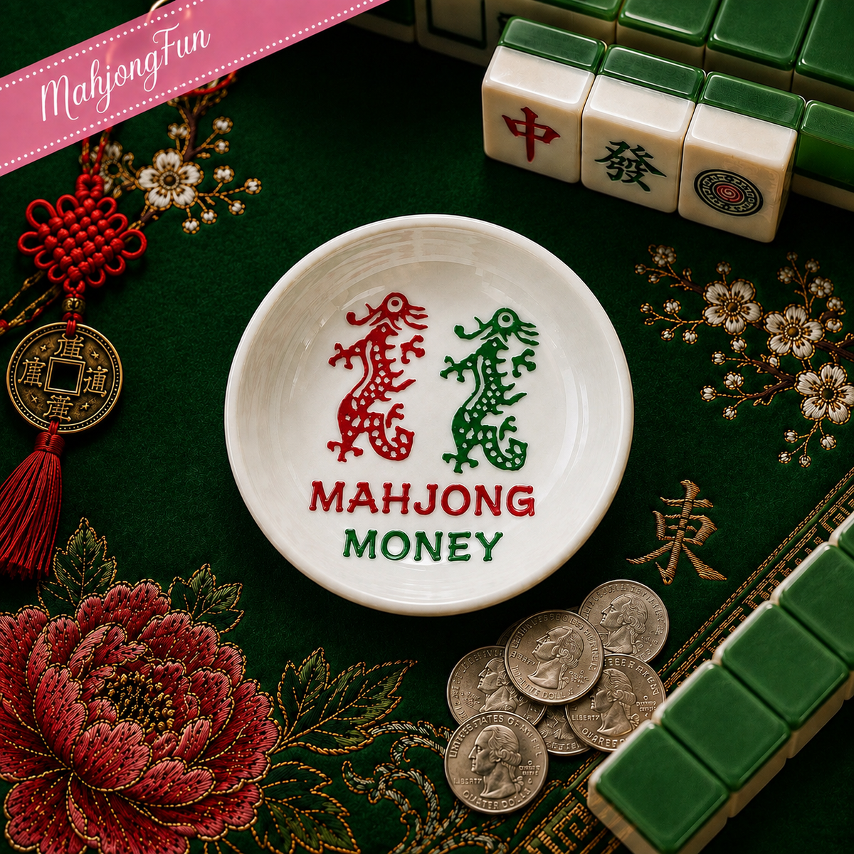 A white ceramic mahjong money dish with red and green dragon motifs and the text 'MAHJONG MONEY' in red and green, styled on a green embroidered tablecloth with mahjong tiles, coins, and decorative Chinese ornaments.