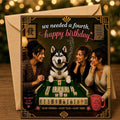 A square birthday card with a yellow envelope, featuring a humorous mahjong-themed illustration with three women and a dog. The card reads 'we needed a fourth, happy birthday' in white and pink script, with a warm, festive background.