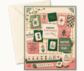 A square birthday mahjong themed greeting card with a retro mahjong theme, shown with an off-white envelope behind it. The card features a beige grid background decorated with pink and green mahjong tiles, Chinese characters, floral illustrations, and playful text like 'Happy Birthday Let's Play!' and 'Another Winning Year!'.