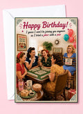 A retro-themed birthday greeting card featuring a vintage illustration of five women playing mahjong, with the text 'Happy Birthday! I guess I won't be joining you anymore as I tried a joker with a pair'. The card is displayed with a white envelope against a solid pink background.