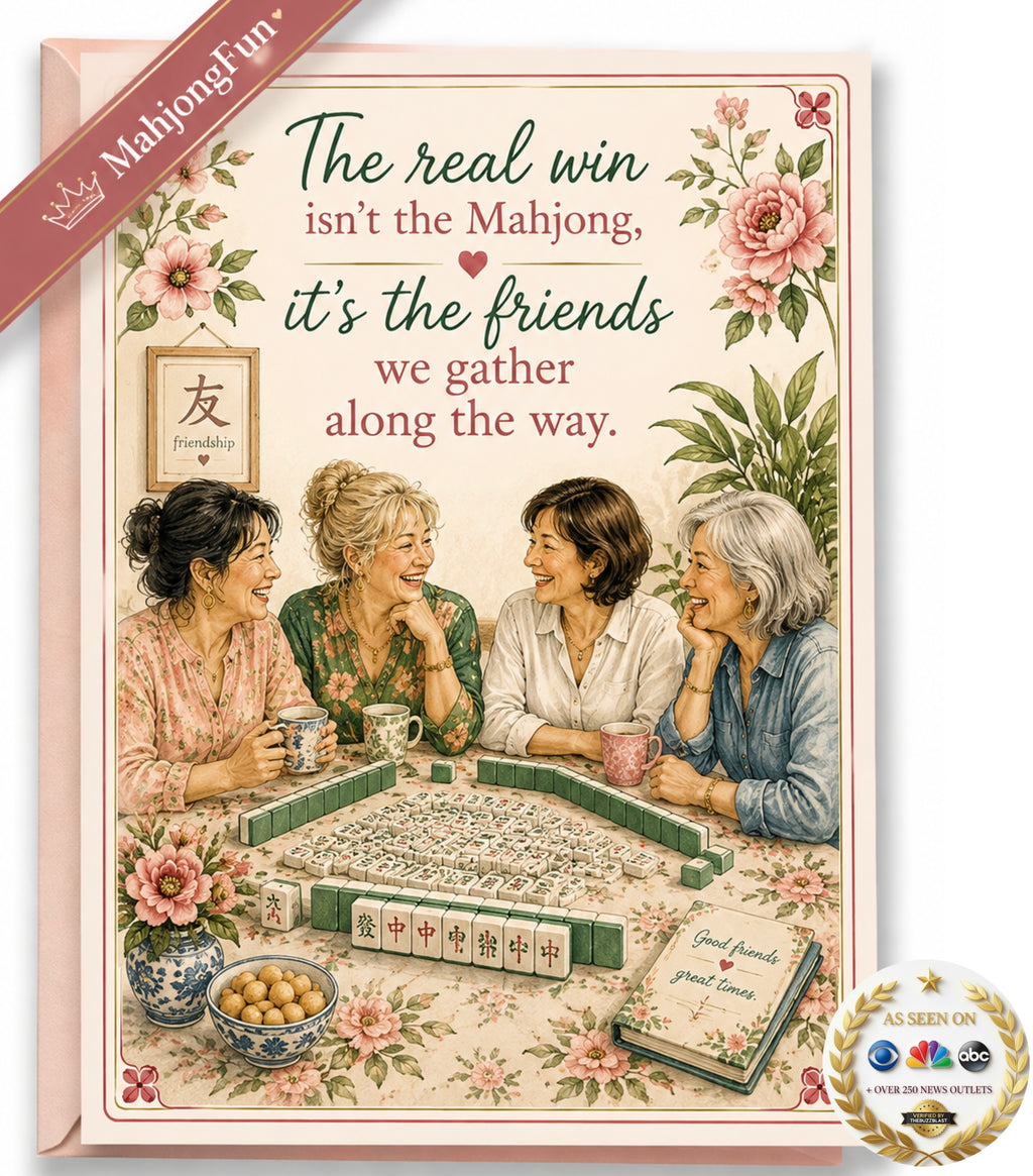 A floral greeting card or art print featuring four women gathered around a mahjong table, with decorative pink flowers and the text, 'The real win isn't the Mahjong, it's the friends we gather along the way.' A pink ribbon banner reads 'Mahjong fun!' and a round seal says 'As seen on The NBC with ABC.