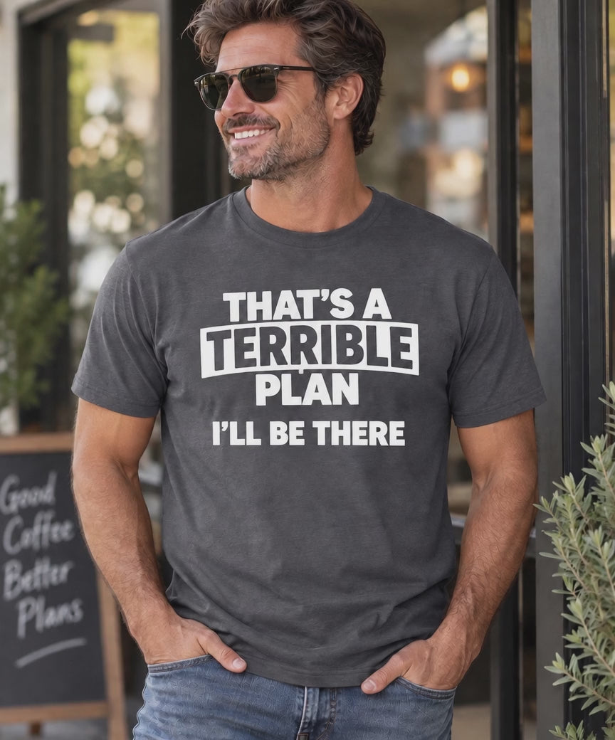 A video of a man wearing a gray graphic t-shirt with the white printed text 'THAT'S A TERRIBLE PLAN I'LL BE THERE', standing in front of a storefront.